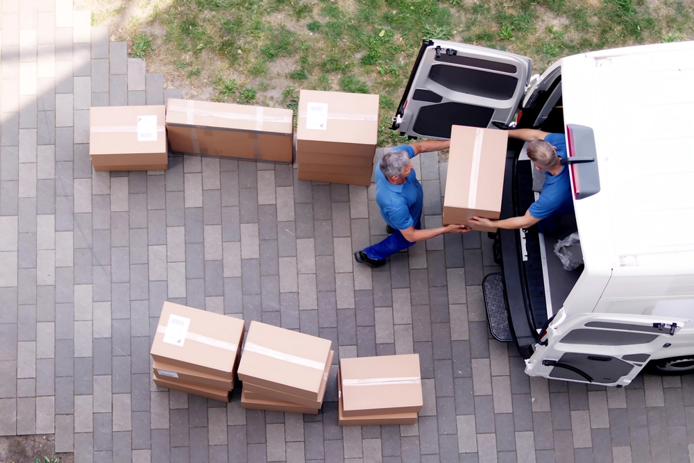 movers,carrying,heavy,boxes,while,moving,with,truck